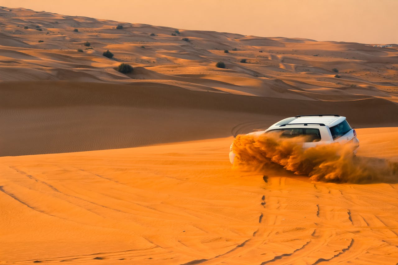 Land Cruiser dune bashing on red sand dunes near Dubai